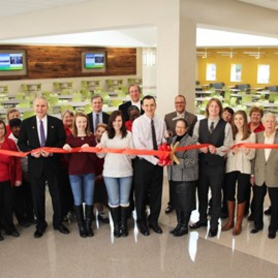 Lindbergh High School Principal Eric Cochran and Chartwells Director of Dining Services Gloria Holliday, center with scissors, celebrate the grand opening of the Lindbergh High cafeteria expansion on Friday. They are joined by students, administrators, Board of Education members and Chartwells staff.