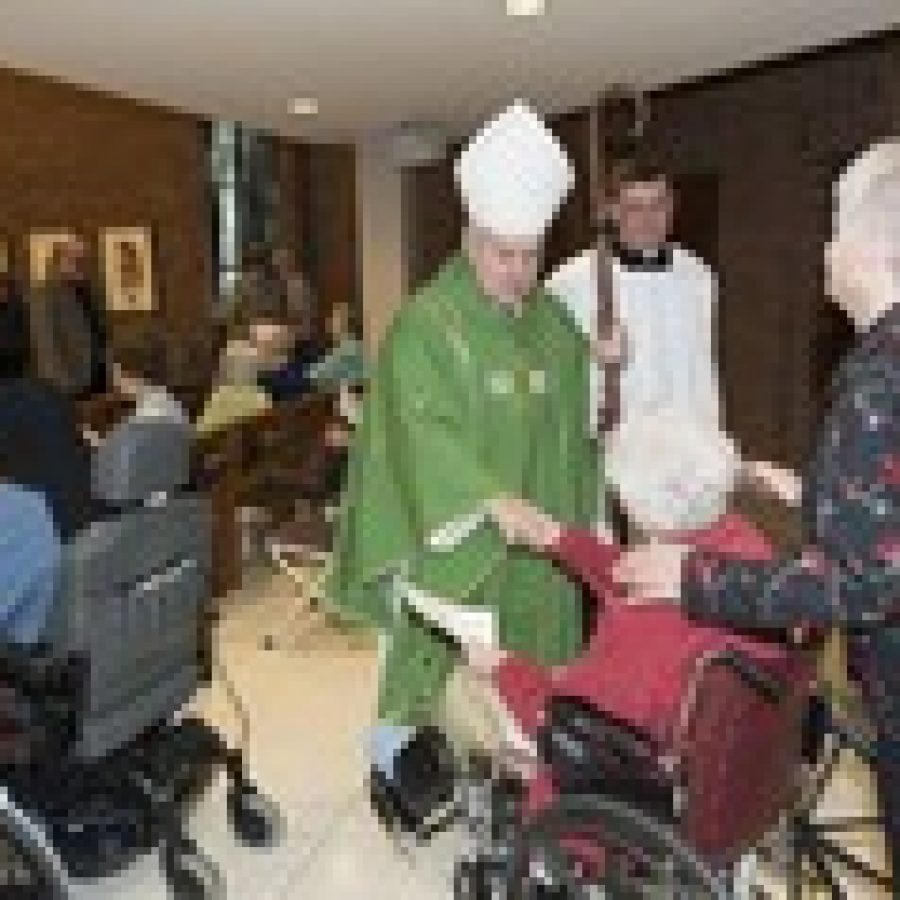 The Most Rev. Robert Carlson, archbishop of St. Louis, visits with a Nazareth Living Center resident and Sister Suzanne Wesley, CSJ, a province leader of the Sisters of St. Joseph of Carondelet. 
