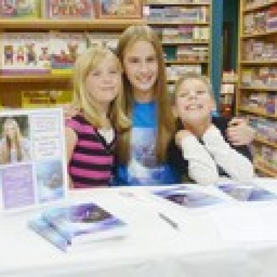 Hannah Hoffmeister, 14, is the author of a book series called The Dream Ring Series. Hannah, a freshman at Oakville Senior High School, is pictured with Ayden and Carleigh Schuster at a book signing at KDs Books in Lees Summit. 