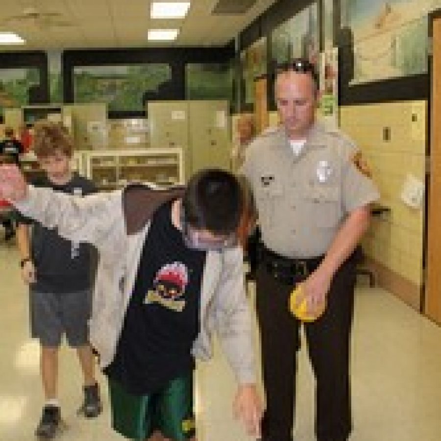 Truman Middle School School Resource Officer Jeff Kriska uses special goggles to show students how drinking can impair motor functions. 