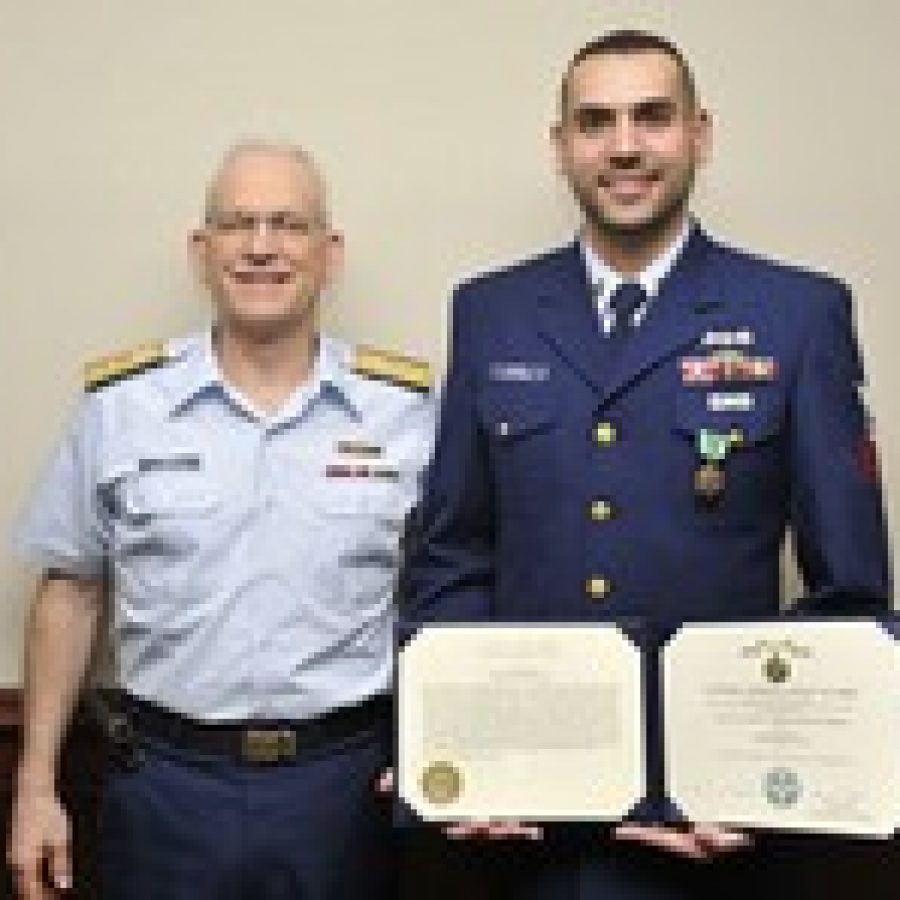 Petty Officer 1st Class Josip Pehar, right, was presented the Coast Guard Commendation Medal and a plaque recognizing his outstanding performance as Enlisted Person of the Year by Rear Adm. Roy A. Nash, left. 
