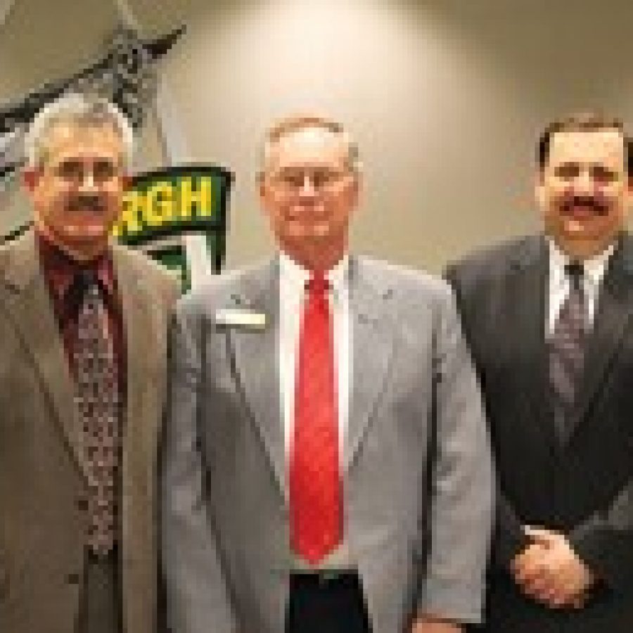 Departing board members Ken Fey, left, and Mark Rudoff, right, are shown with Board of Education President Vic Lenz at last weeks meeting. 