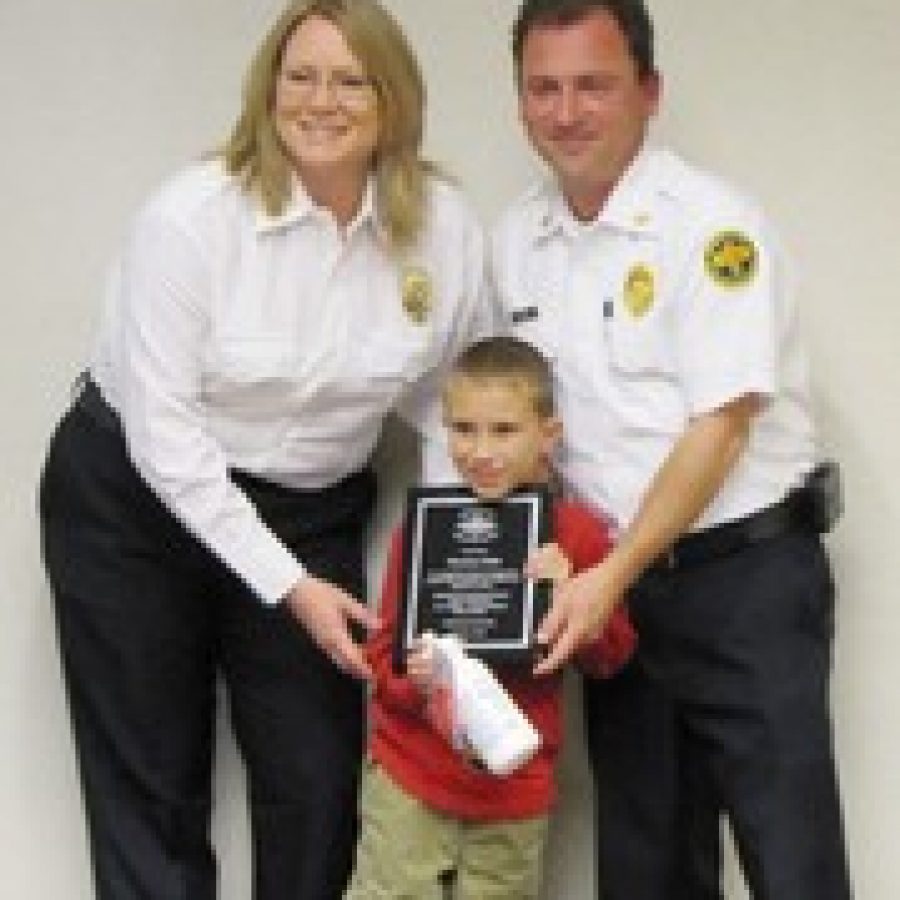 Thomas Hale is shown with Amy Reitz of South County Fire Alarm and Mehlville Fire Protection District Chief Brian Hendricks. Thomas was recognized for his heroic efforts when he called 911 after his mother suffered a seizure. 