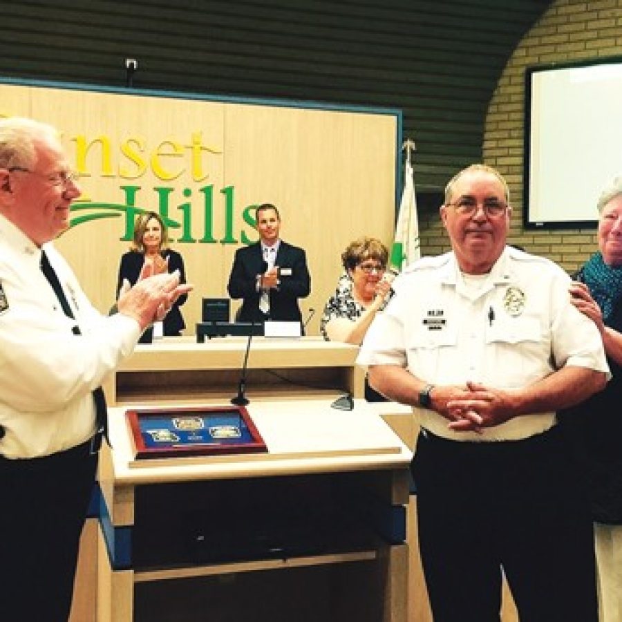 Sunset Hills officials, including Police Chief William LaGrand, left, congratulate Lt. Mike Swofford, who is retiring June 1 after 43 years of service, at the May 10 Board of Aldermen meeting. The chief also recognized Swoffords wife, Becky, for her unofficial contributions to the city and the Police Department. Also pictured in background, from left, are: Ward 4 Alderman Thompson Price, Mayor Pat Fribis, Ward 2 Alderman Steve Bersche, Recording Secretary Carol Lay and City Attorney Robert E. Jones.