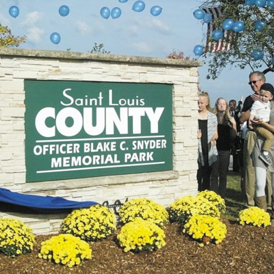 Elizabeth Snyder and her son Malachi, right, are pictured last week after the unveiling of the sign for Officer Blake C. Snyder Memorial Park. Hundreds of county officers and dignitaries attended the Nov. 2 ceremony in Green Park.