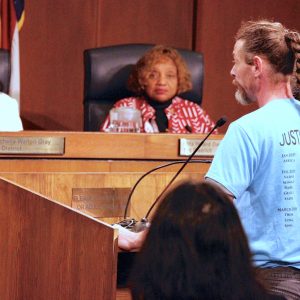 A volunteer from the St. Louis County animal shelter addresses the St. Louis County Council at a 2019 meeting.