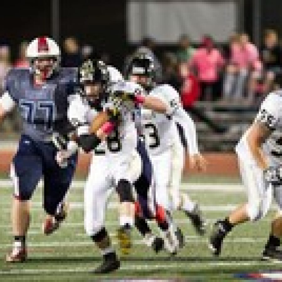 Oakvilles Connor Bartow, No 28, is pursued Parkway Souths Steve Greer, No. 77, in Friday nights game. The Tigers prevailed 31-19. Photo by Megan LeFaivre-Zimmerman
 