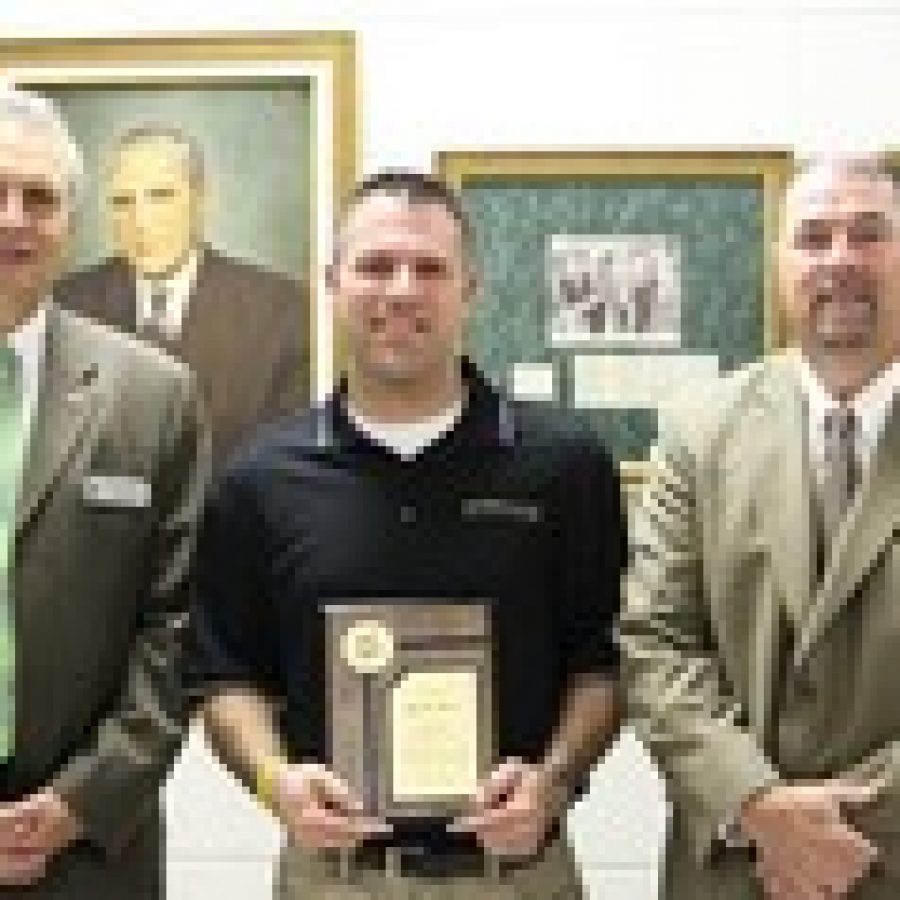 Superintendent Jim Simpson, left, and Assistant Superintendent of Personnel Rick Francis, right, present the 2012-2013 Lindbergh Teacher of the Year Award to Brian Wyss, middle-school director of bands.
 