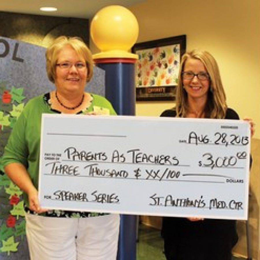 Mehlville Parents As Teachers Coordinator Barb Ehlen, left, accepts a \$3,000 St. Anthonys Medical Center Partnership Grant from, Laura Bub, the hospitals community outreach coordinator. 