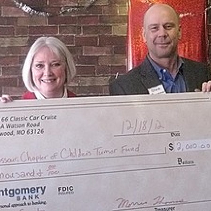 Steve Boggeman, right, Route 66 Classic Car Cruise chairman, presents Patricia Hurst, of the Missouri Chapter of the Childrens Tumor Fund, with a check for \$2,000. 