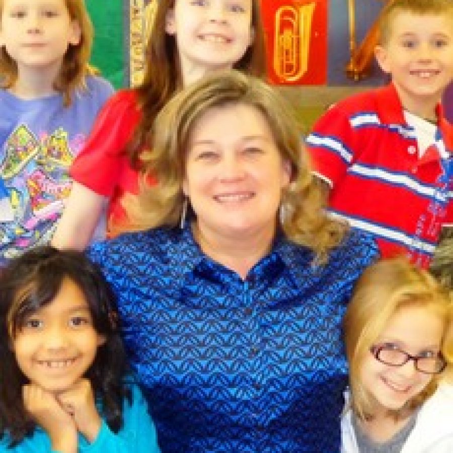 Mesnier Primary School second-graders, clockwise from lower left, Lily Kohler, Elleanor Stark, Ella Malone, Colton MacCachran and Jessica Stevens are pictured with music teacher Laura Bangert. 