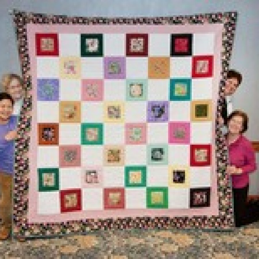 For the second year, in a tight competition with less than 20 votes separating the top two churches, St. Pauls Catholic Church, of Fenton, beat out St. Dominic Savio, of Affton, to win Friendship Village Sunset Hills fourth annual Quilting Competition. Winning quilters, from left, Erlinda Madridondo, Ruth Finder, Donna Robinson and Mary Haukap, kneeling, display their winning quilt. 