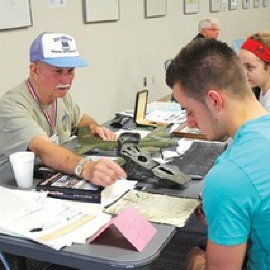 Frank Finklang, a member of the Army Air Corps 301st Bombardment Group, shares a map and artifacts with Lindbergh High School students during the third annual History Alive program in 2012.
 