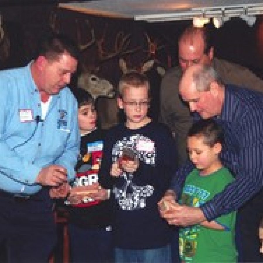 Mitch Norris, left, of the St. Louis Chapter World Turkey Federation, gives turkey-calling lessons to youngsters at the First Baptist Church of Oakvilles fourth annual Pioneer Harvest Dinner.
 