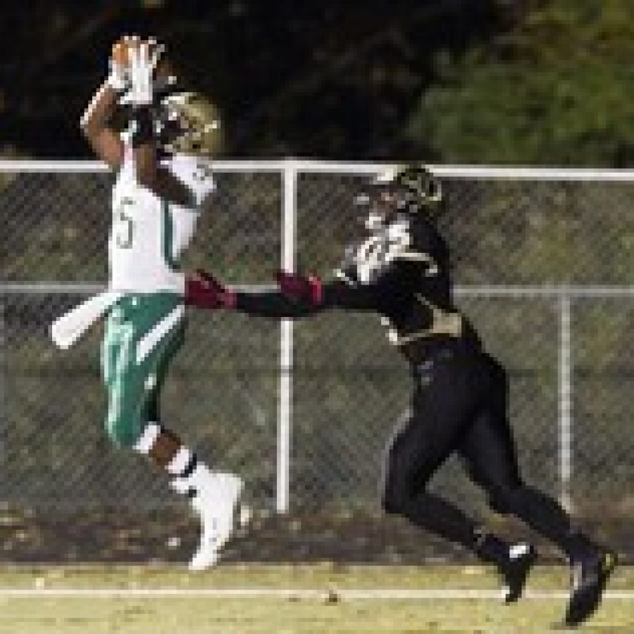 Lindberghs Reggie Guynn, No. 5, catches a pass as Oakvilles Arsante´ Conners prepared to take him down in Friday nights game. Photo by Megan LeFaivre-Zimmerman
 