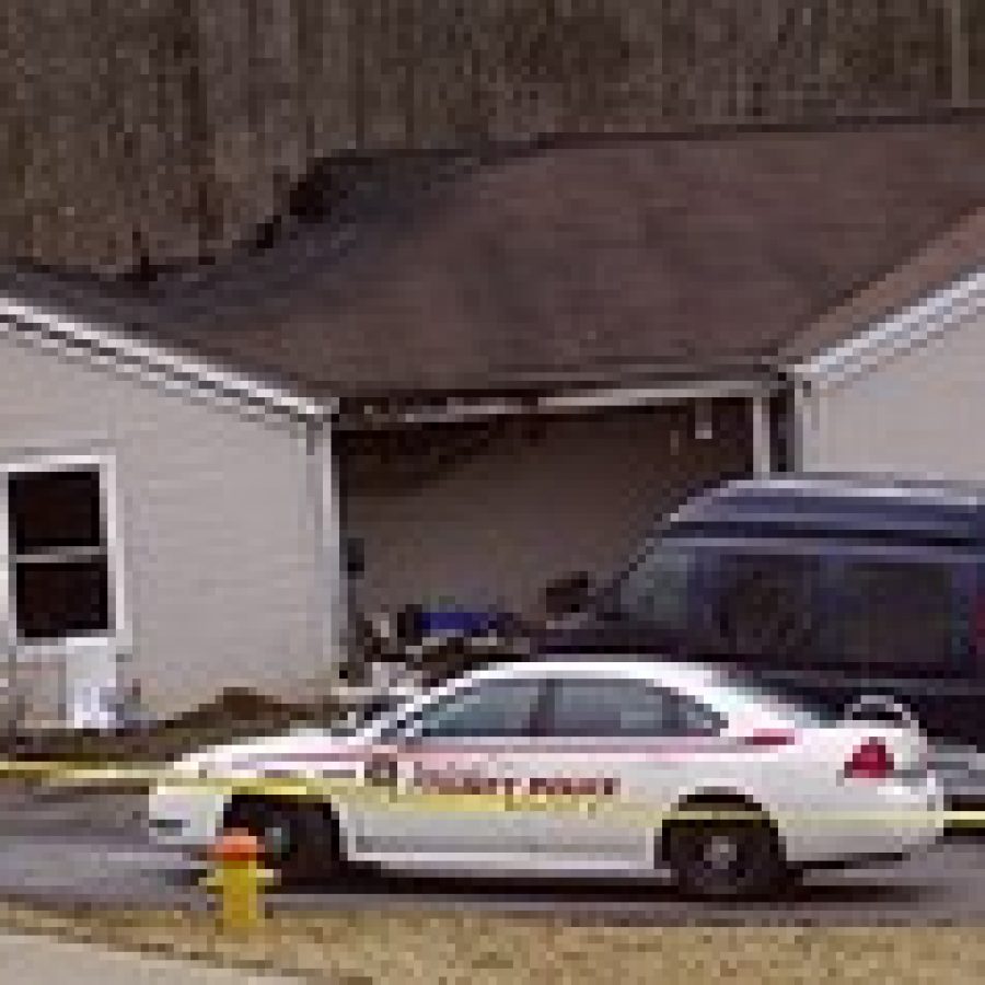 Police tape surrounds the charred Kinswood Lane duplex where firefighters iscovered the body of Mark J. Woods on Feb. 23, 2011.  Photo by Bill Milligan 