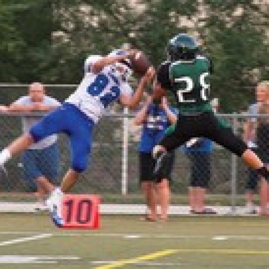 Northwests Andrew Ide, No. 82, and Mehlvilles Mike Mik, No. 28, go for the ball early in Friday nights game.
Megan LeFaivre-Zimmerman photo 