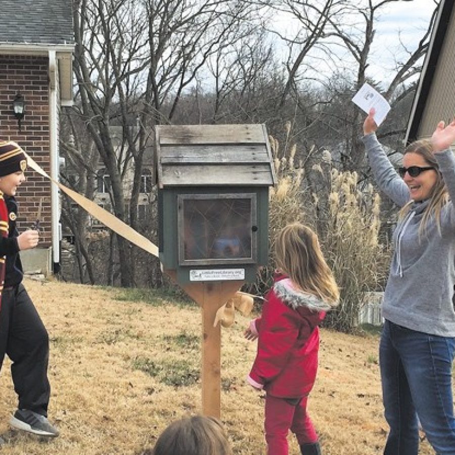 Jenny Bess, right, celebrates the official opening of Oakvilles new Little Free Library with her children, from left, Sawyer, 10, and Lottie, 6.