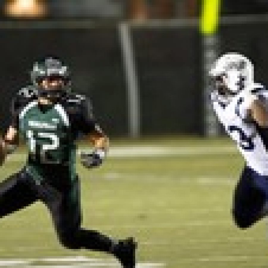 Mehlville Senior High School quarterback Brendan Moore, left, eludes SLUHs Bryan Edwards in Friday nights game.Megan LeFaivre-Zimmerman photo 