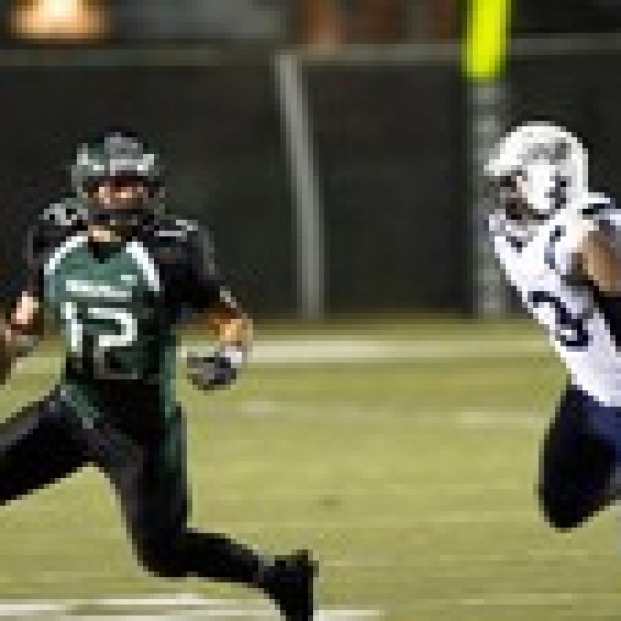 Mehlville Senior High School quarterback Brendan Moore, left, eludes SLUHs Bryan Edwards in Friday nights game.
Megan LeFaivre-Zimmerman photo
 