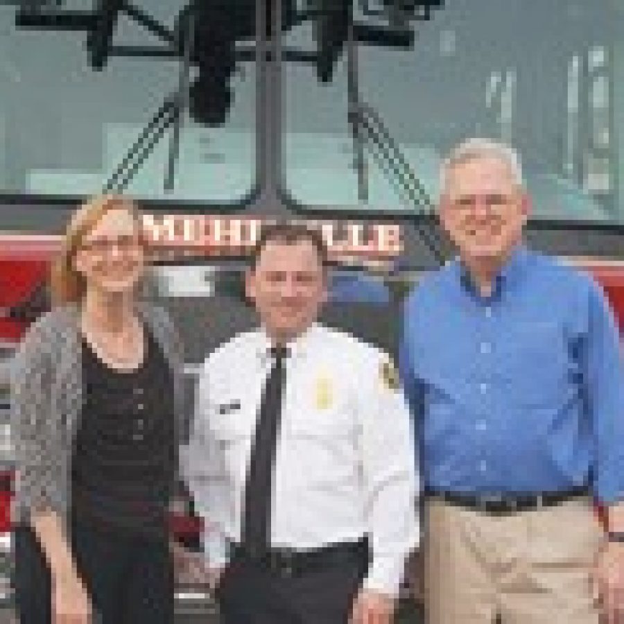 Mehlville Fire Protection District Board of Directors Treasurer Bonnie Stegman, Chief Brian Hendricks and board Secretary Ed Ryan are shown with the fire districts 75-foot aerial ladder truck. 