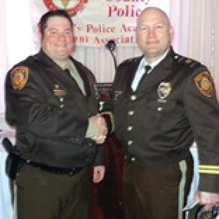 Officer of the Year Kevin Helldoerfer, left, is congratulated by Capt. Jim Schneider of the South County Precinct.  