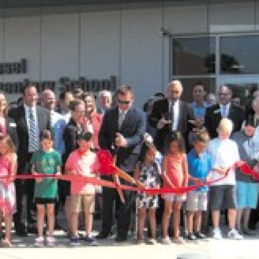 Lindbergh Schools Board of Education members, administrators, teachers and staff gathered last week along with former school board members, state and local elected officials, community leaders and members of the Dressel family to celebrate the opening of the districts 650-student Dressel Elementary School, as Dressel students cut the ribbon for the new state-of-the art school on the direction of Superintendent Jim Simpson, arms extended. Mike Anthony photo.