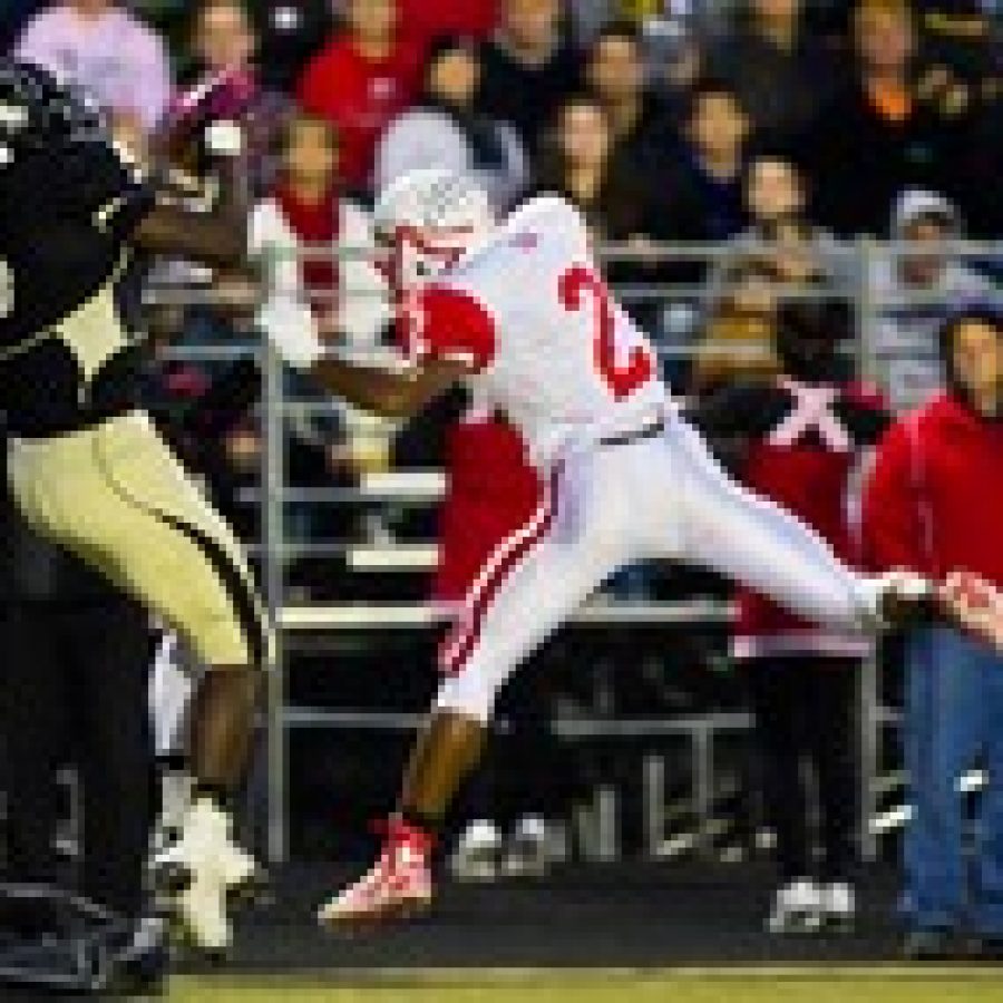 Oakvilles Arsante Conners, No. 5, catches this pass in the first quarter of Friday nights game despite the efforts of Foxs Andre McIntyre, No. 2. He went on to score a touchdown. Photo by Megan LeFaivre-Zimmerman 

 