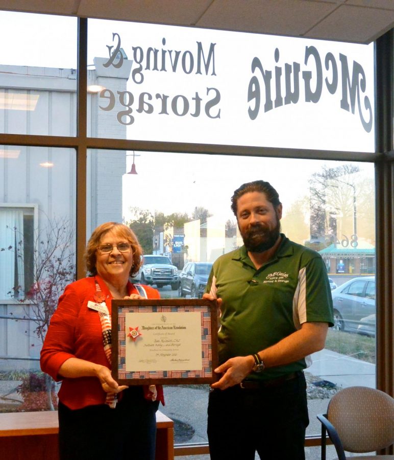 Josh McGuire, right, was honored in November 2020 by the Olde Towne Fenton NSDAR chapter, represented by Regent Linda Kanevsky, left, for using his company to store and transport wreaths across the country for Wreaths Across America. 