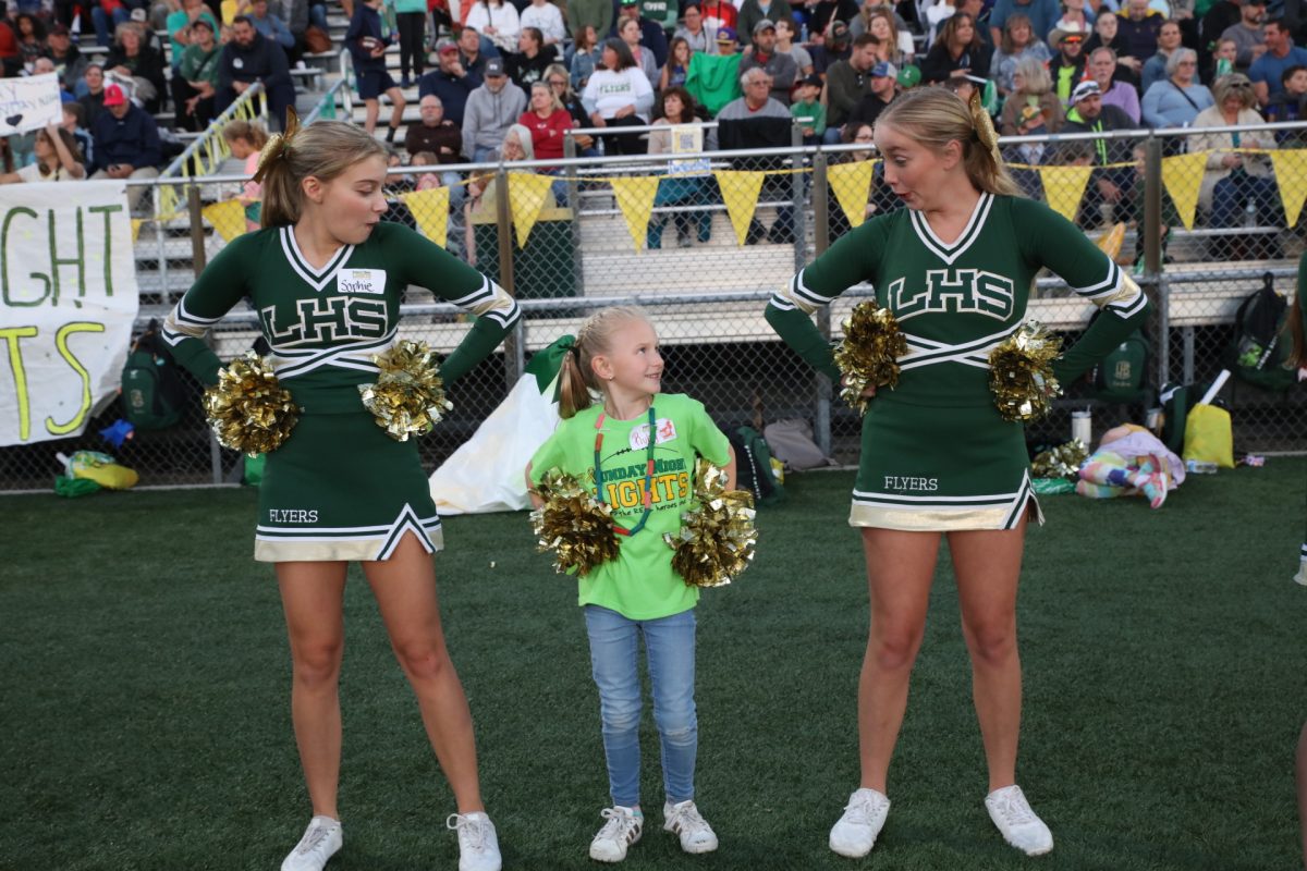 The Lindbergh Schools community held its 14th annual Sunday Night Lights event on Oct. 8, giving heroes – children and individuals battling cancer and other life-threatening illnesses – the chance to experience and participate in a high school football game under the lights. Pictured above, two Lindbergh High School cheerleaders goof around with a young hero who chose to be a cheerleader for the night. “To see that friendship that just happens between a high schooler and a buddy … that’s really, really cool,” Lori Krueger, president of Sunday Night Lights, said.