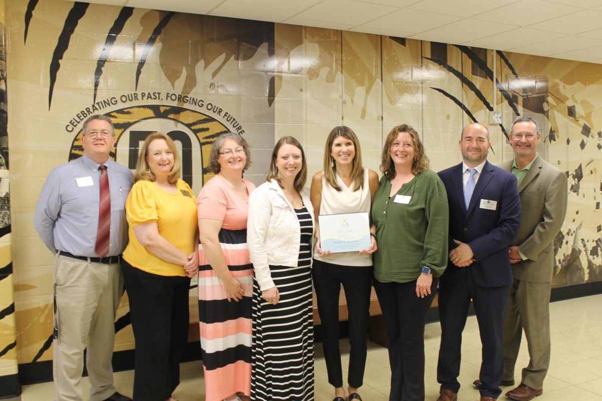 Katie+Dowd%2C+pictured+above+center+with+the+certificate%2C+was+awarded+the+Starfish+Award+by+the+Special+Education+Foundation+for+her+work+with+the+Special+School+District.+Photo+courtesy+of+the+Mehlville+School+District.
