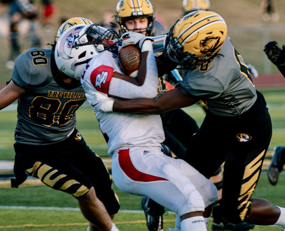 The Oakville Tigers battle it out on the field during their 39-20 win over Parkway South on Sept 6. The team racked up nearly 500 yards of offense, helping the Tigers bounce back from a tough week one loss and even their record at 1-1. Photo by Jeremy Housewright.