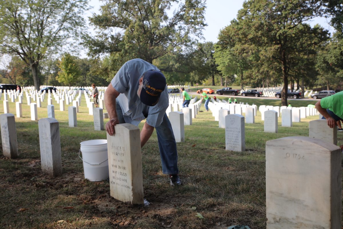 In honor of Patriot Day, community members clean headstones at Jefferson Barracks National Cemetery on Sept. 11. Though the event takes place annually, local participation skyrocketed this year, with numbers tripling from about 40 to 50 people annually to 150 volunteers this year.