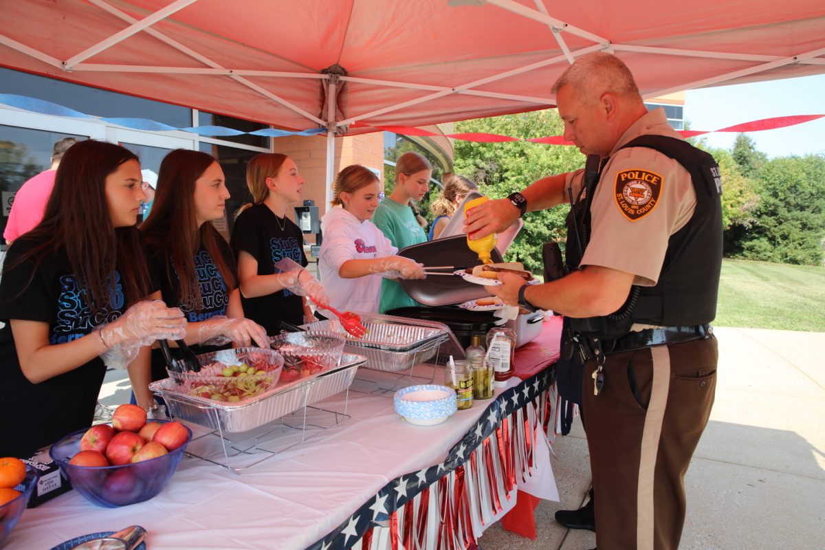 Bernard Middle School Student Council members serve lunch to a St. Louis County police officer at the school’s 14th annual Patriot Day BBQ on Sept. 11. Approximately 150 first responders attended the event. 