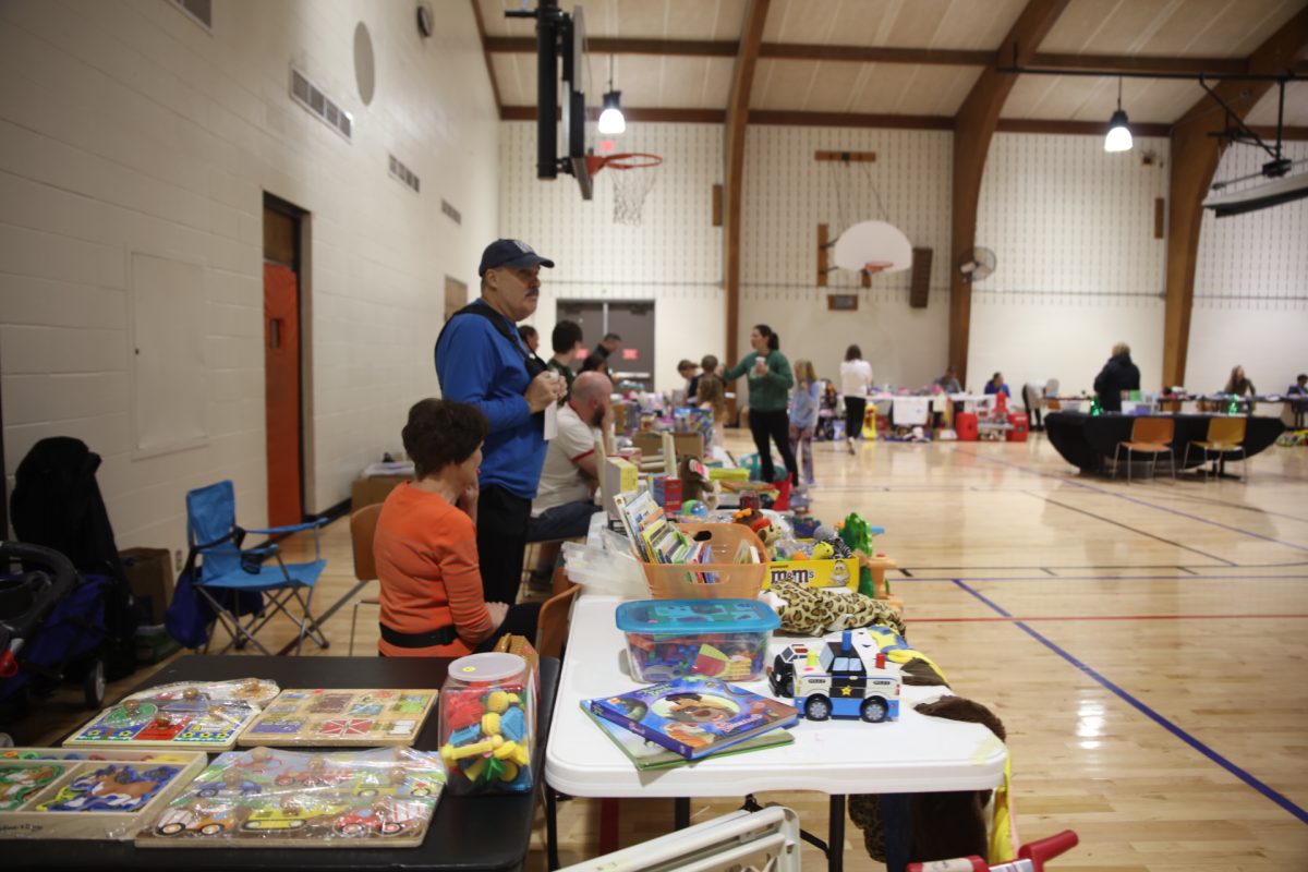 Crestwood community members sit at their booth, waiting for customers at the 2024 Kids Garage Sale. 