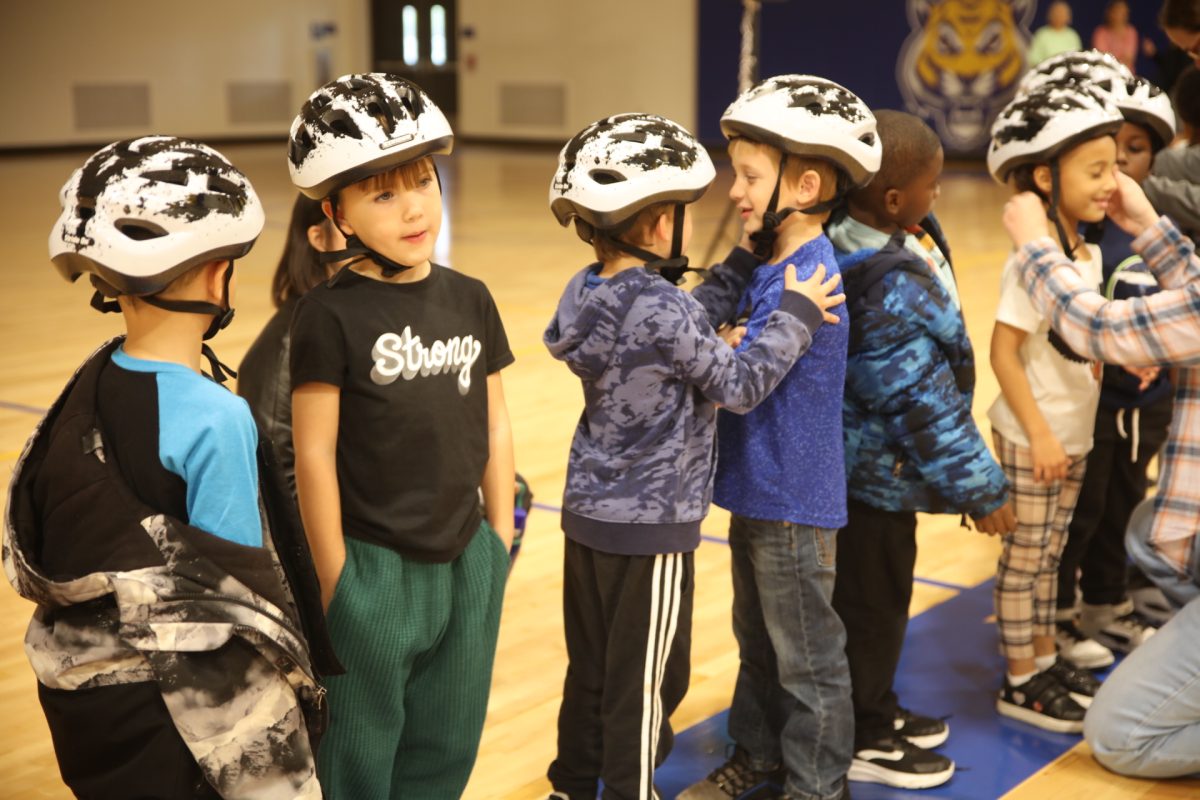 Select students line up to test the new bikes.