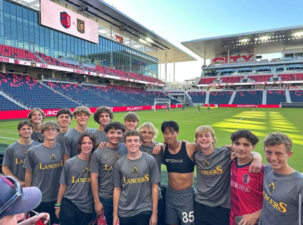 Members of the Lutheran South High School varsity boys soccer team smile with St. Louis City SC player  Hosei Kijima after a City game. Photo courtesy of Lutheran South High School.