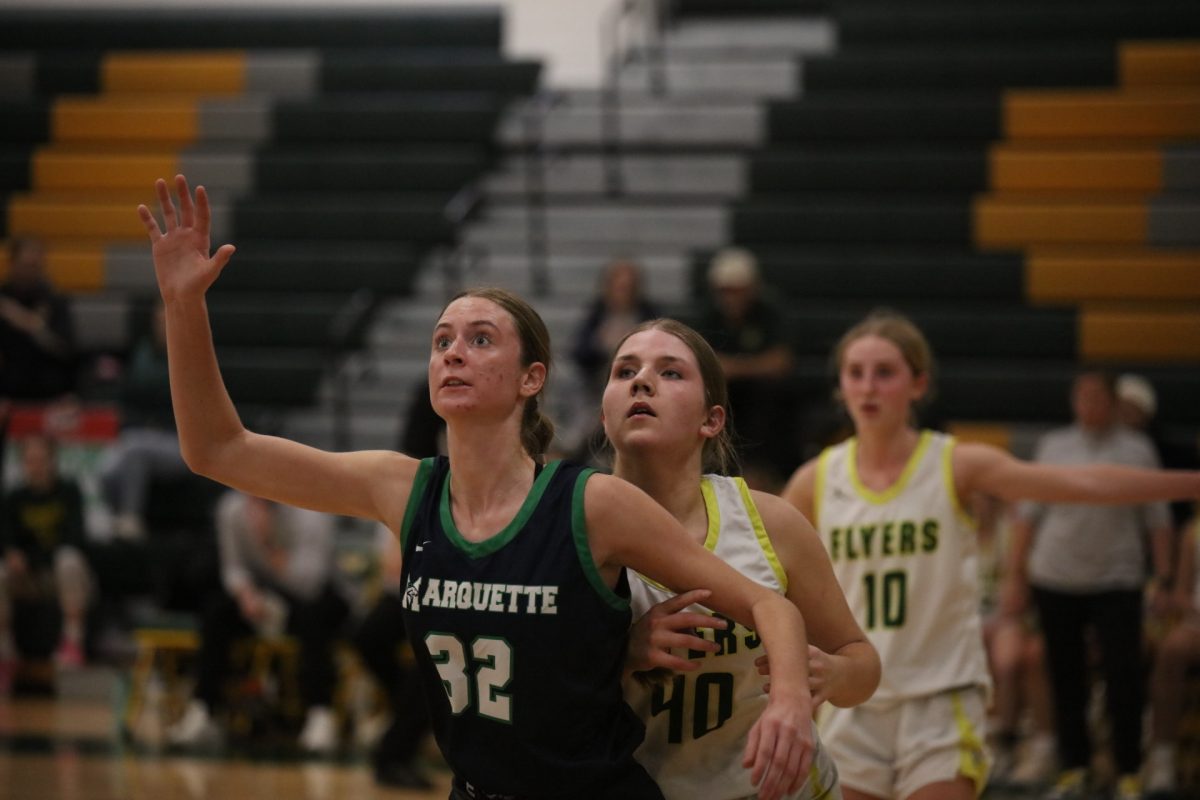 A Marquette player (32) blocks Lindbergh forward Samantha Colvin (40), a senior at LHS, who attempts to make space to receive the ball.
