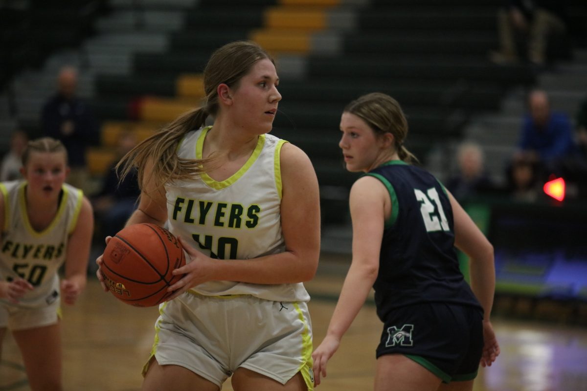  Lindbergh forward Samantha Colvin (40) looks downcourt for a possible pass, doubling back to make room from defending a Marquette player (21).
