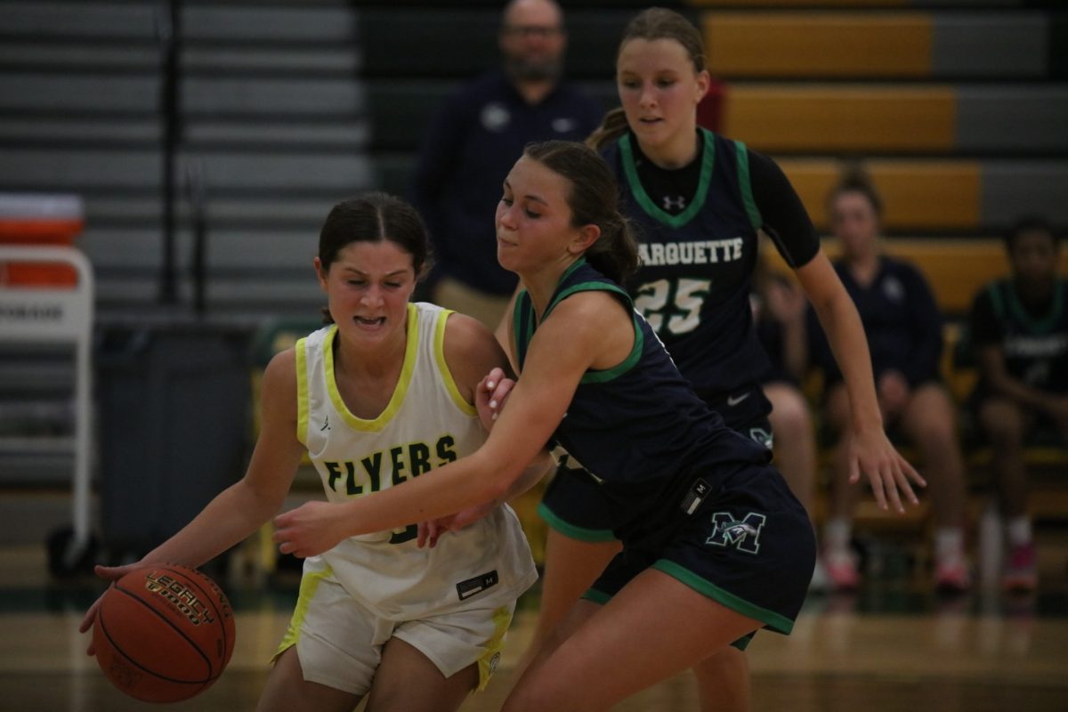 Lindbergh guard MJ Abercrombie (3), a junior at LHS, takes possession of the ball, defending it from a Marquette player with an arm bar.
