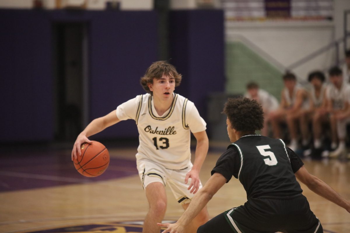 Oakville Guard Jack Storck (13)  faces off against  Mehlville’s Jordan Hannam-Lewis who blocks his route downcourt.