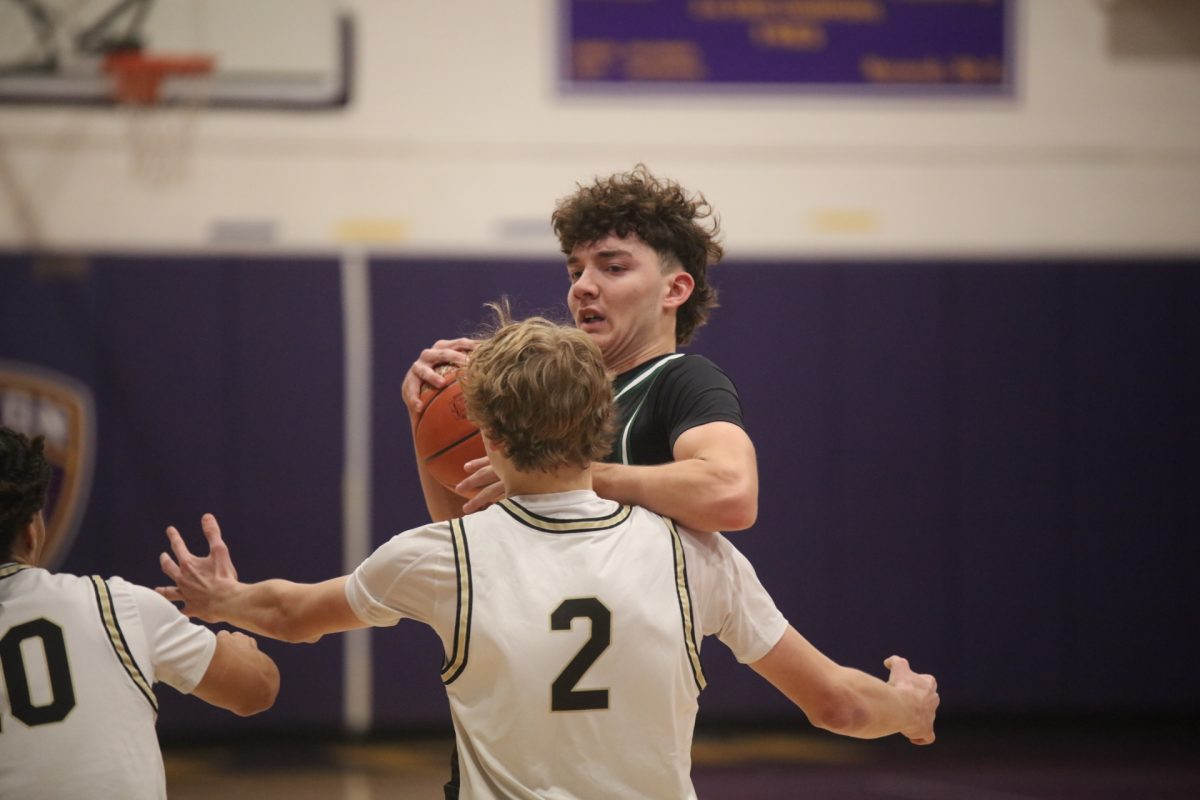 Mehlville player Brady Sights (10) clutches the ball close to him as Oakville Max Simokaitis (2) blocks him.