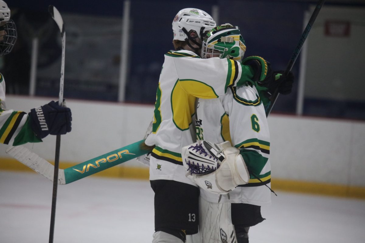 Lindbergh Forward Brodie Rybar (13) congratulates goalie Colin Gerrein (6) post-victory with a hug.