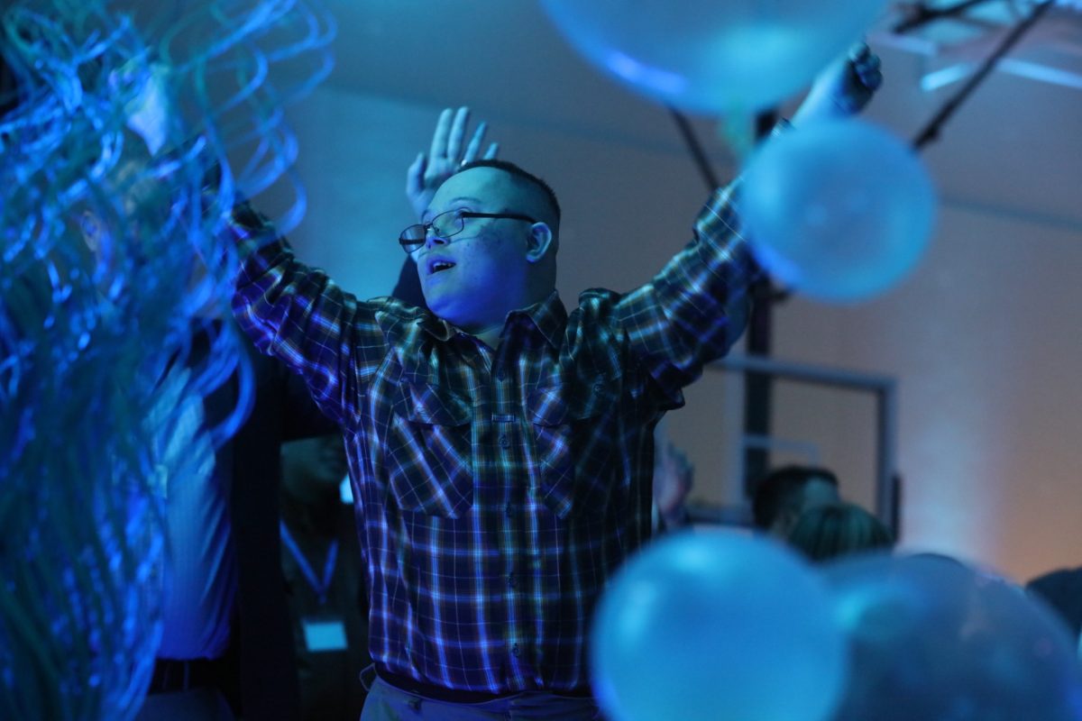 A "Night to Shine" attendee jumps and dances to the music.