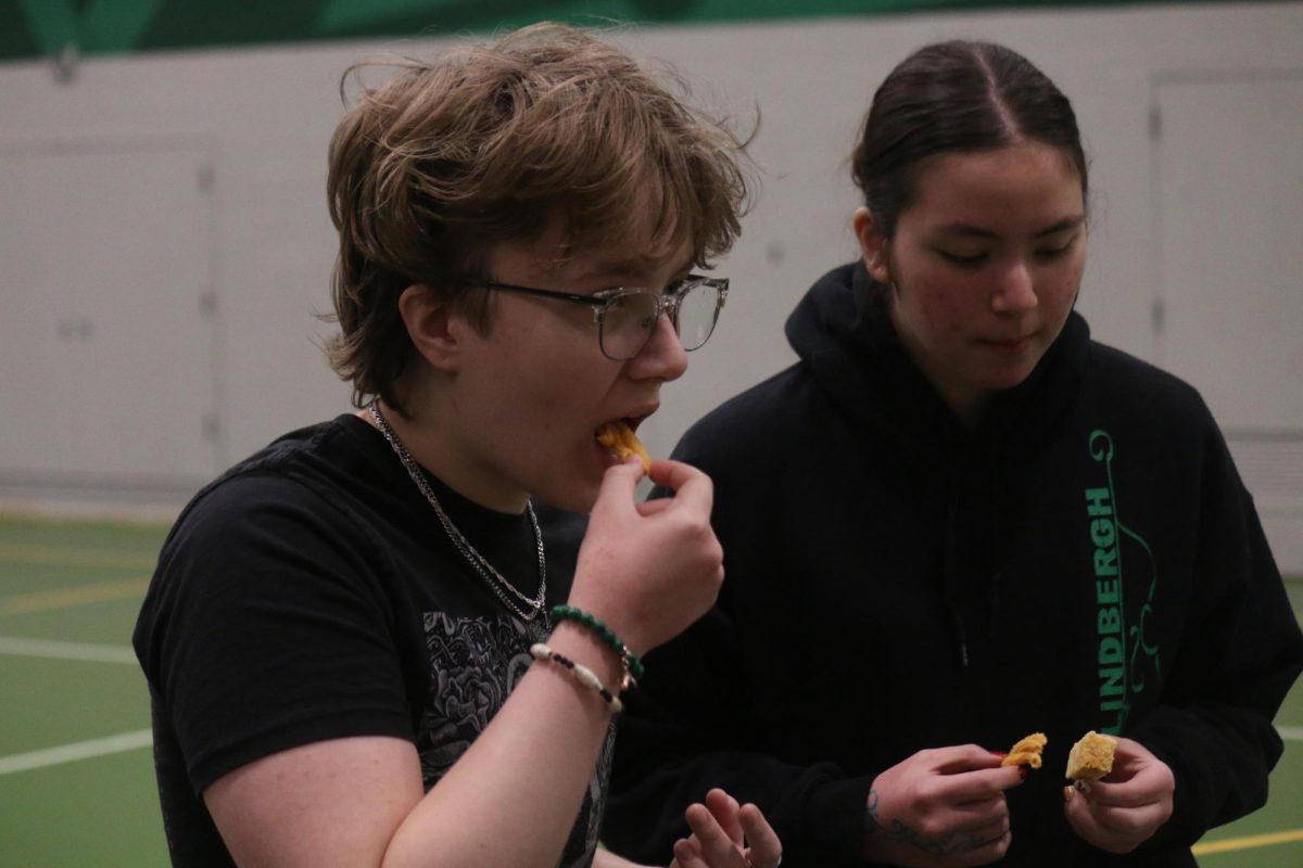 Two Lindbergh students try dharwad peda, an Indian sweet.
