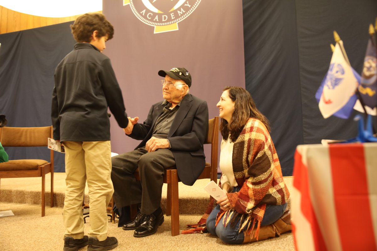 Students shake Luttrell’s hand following his presentation.