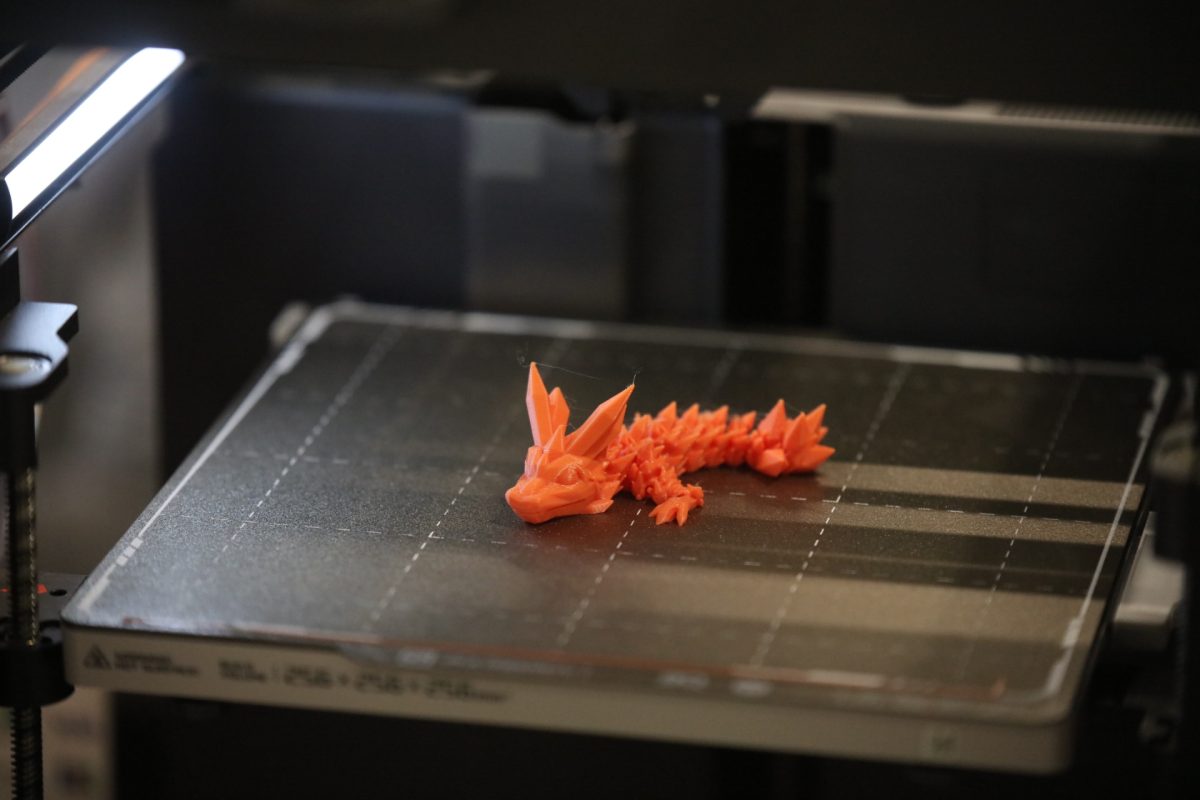 A vendor uses a 3D printer to create a dragon at the Crestwood-Sunset Hills Rotary Club's spring 2025 “Arts and Crafts Fair." 