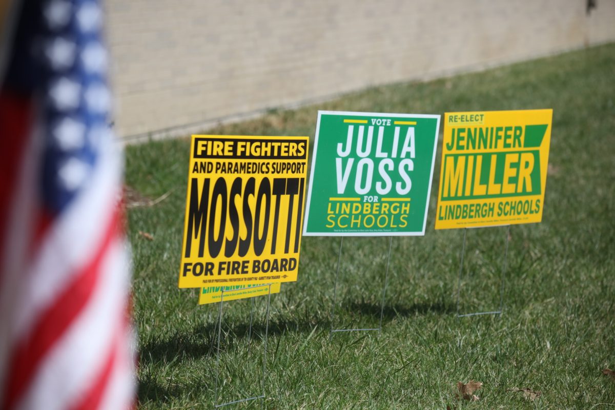 Multiple candidate signs were seen in the grass outside the doors to Lindbergh High School.