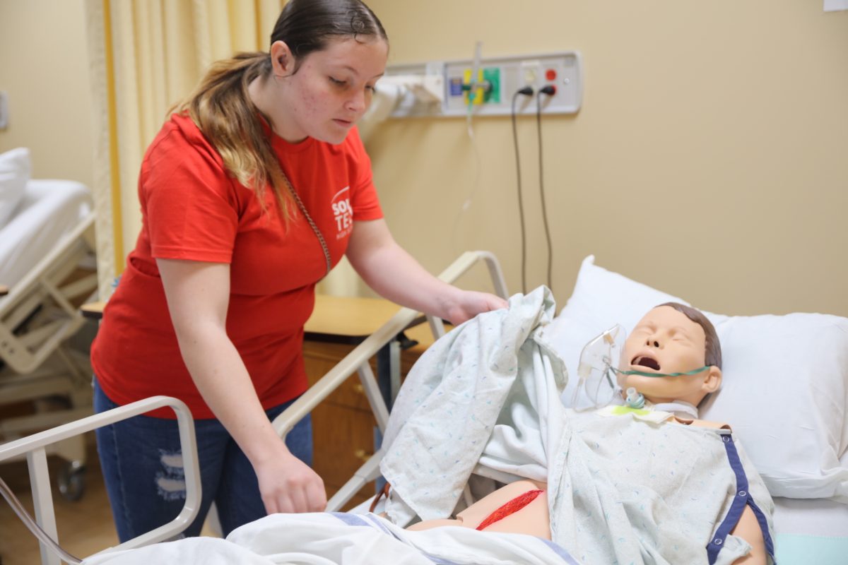 A student examines a mannequin during “What’s Wrong with This?”