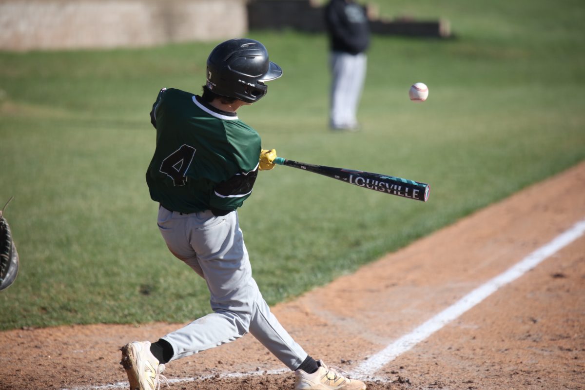 Mehlville's #4 swings at the nearing ball. 